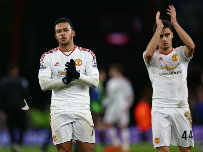 Manchester United's Memphis Depay (L) and Andreas Pereira applaud fans at the Vitality Stadium after their loss to AFC Bournemouth.