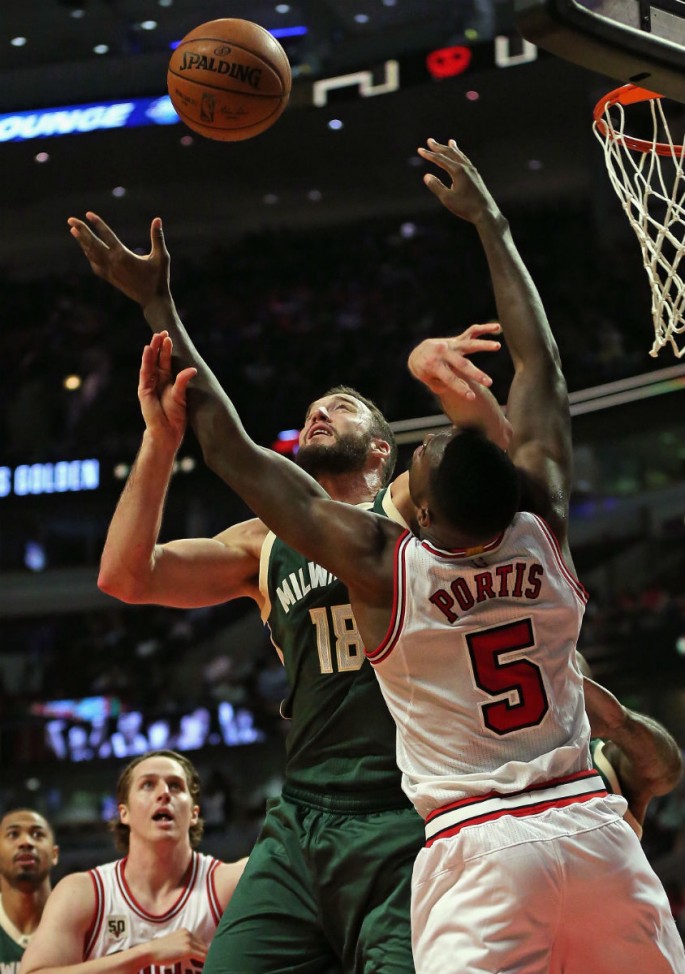 Milwaukee Bucks center Miles Plumlee rebounds against Chicago Bulls' Bobby Portis.