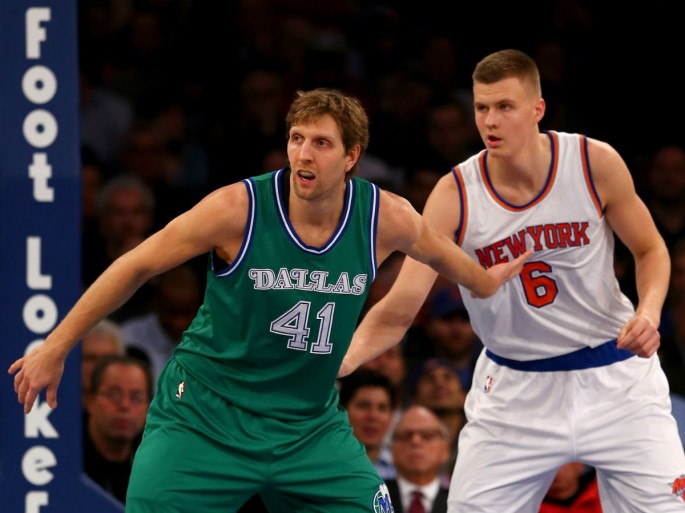 New York Knicks rookie Kristaps Porzingis defends Dallas Mavericks' Dirk Nowitzki.