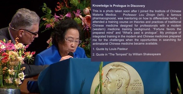 The master of ceremony holds the mic for Tu Youyou as she delivers her lecture.