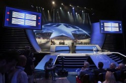 A general view of the screens shows the draw for the 2015/2016 UEFA Champions League Cup soccer competition at Monaco's Grimaldi Forum in Monte Carlo 