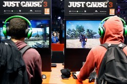 Visitors play a video game 'Just Cause 3' at the Paris Game Week, a trade fair for video games on October 28, 2015 in Paris, France. Paris Game week will run from October 28 until November 1, 2015. 