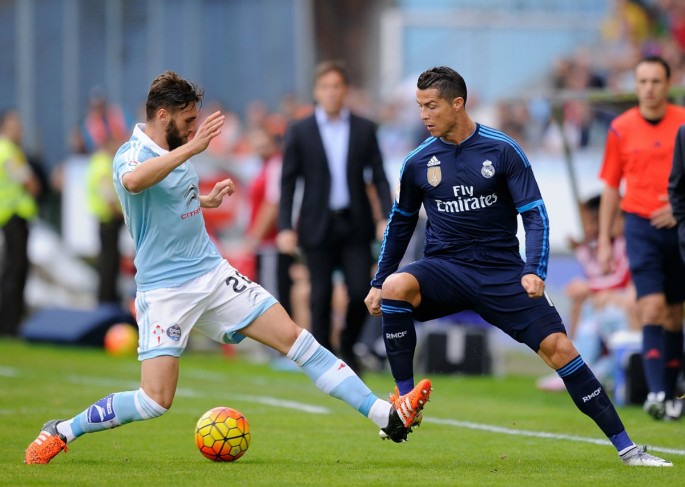 Celta Vigo defender Sergi Gomez (L) competes for the ball against Real Madrid's Cristiano Ronaldo.