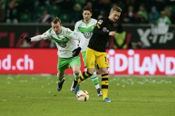 Wolfsburg midfielder Maximilian Arnold (L) competes for the ball against Borussia Dortmund's Marco Reus.