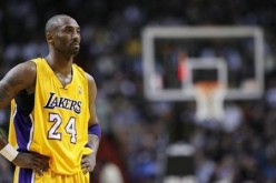 Los Angeles Lakers' Kobe Bryant watches a Miami Heat free throw in their NBA basketball game in Miami, Florida January 19, 2012.