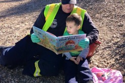 Firefighter Reading to Boy