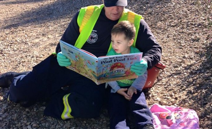 Firefighter Reading to Boy