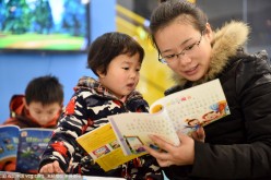 Customers read books in the Tongling City Library in east China's Anhui Province on Jan. 3, 2016.