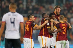 Roma players celebrate striker Umar Sadiq's goal against Genoa.