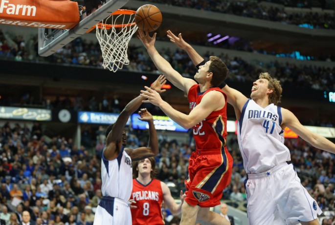 Jimmer Fredette goes up for a layup against Dallas Maverick's Dirk Nowitzki during his stint with the New Orleans Pelicans last season.