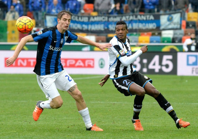 Udinese defender Edenilson (R) competes for the ball against Atalanta's Andrea Conti.