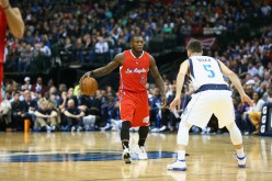 Former NBA Slam Dunk champion Nate Robinson (L) goes against Dallas Mavericks' J.J. Barea during his stint with the Los Angeles Clippers.