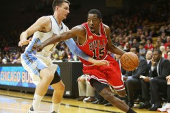 Guard Jordan Crawford (#15) drives against a Denver Nuggets defender during his stint with the NBA's Chicago Bulls.