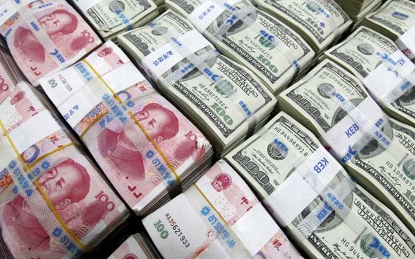 U.S. dollar and Chinese yuan notes at the Korea Exchange Bank in Seoul are seen in this Nov. 10, 2010 photo.