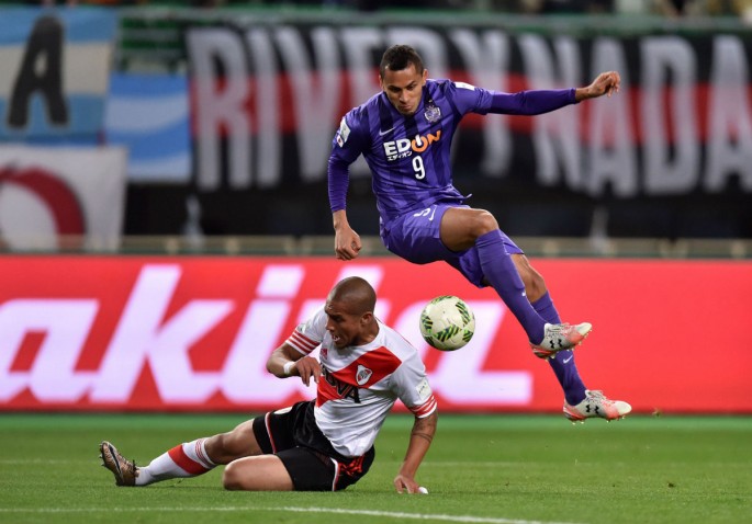 Sanfrecce Hiroshima's Douglas leaps over River Plate's Jonatan Maidana during the semifinals of the 2015 FIFA Club World Cup. The striker is now with Al Ain FC.