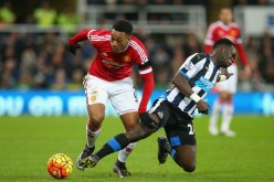 Newcastle United midfielder Cheick Tiote (R) competes for the ball against Manchester United's Anthony Martial.