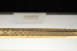 The Goujian sword is almost 56 centimeters long and weighs 875 grams. It is known for its dark rhombic patterns, decorated in blue and turquoise crystals.