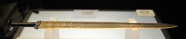 The Goujian sword is almost 56 centimeters long and weighs 875 grams. It is known for its dark rhombic patterns, decorated in blue and turquoise crystals.
