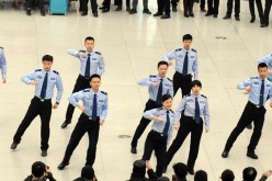 Railway policemen perform at the waiting room of Changchun railway station in Northeast China's Jilin Province on Jan. 24, 2016. The dance is aimed at making passengers happy.
