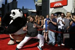 Cast member Jack Black poses with a panda character during the DVD release of 