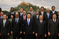 President Xi Jinping (front C) poses for photos with guests at the Asian Infrastructure Investment Bank launch ceremony at the Great Hall of the People in Beijing, Oct. 24, 2014. 