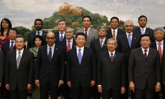 President Xi Jinping (front C) poses for photos with guests at the Asian Infrastructure Investment Bank launch ceremony at the Great Hall of the People in Beijing, Oct. 24, 2014. 