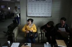 A woman applies for driver training in a driving school in Siheung in Shandong Province.