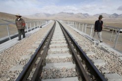 Workers check the tracks along the Qinghai-Tibet railway in Dangxiong Country in Tibet, part of China's large network of railway.