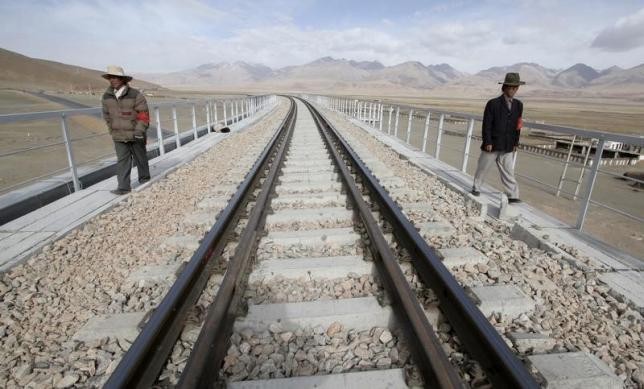 Workers check the tracks along the Qinghai-Tibet railway in Dangxiong Country in Tibet, part of China's large network of railway.