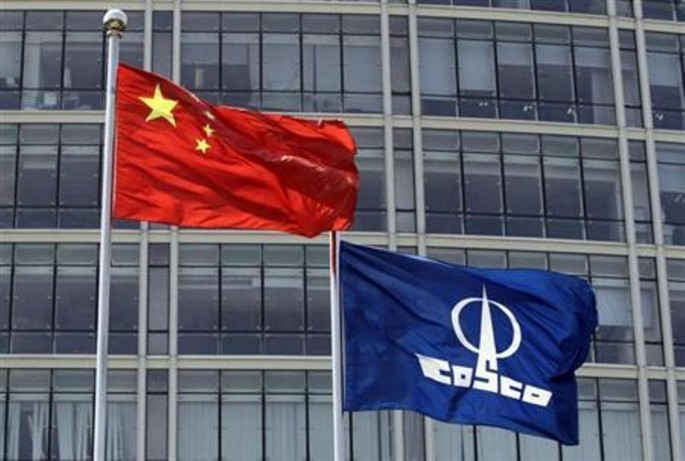 A COSCO company flag and a Chinese national flag fly in front of the company's headquarters in Beijing, Aug. 26, 2010. 