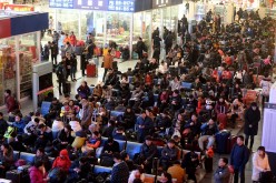 A large number of passengers wait at a railway station as many trains are delayed due to heavy snowfall in Jinan, China, on Jan. 22, 2016.