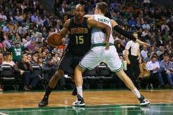 Atlanta Hawks center-forward Al Horford (L) goes around Boston Celtics' Jonas Jerebko.