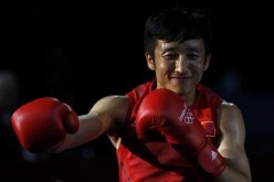 China's Zou Shiming arrives for his Men's Light Fly (49kg) gold medal boxing match against Thailand's Kaeo Pongprayoon at the London Olympics, Aug. 11, 2012. 