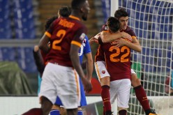Roma winger Diego Perotti is carried by teammate Stephan El Shaarawy (#22) after he scores the team's second goal against Sampdoria.