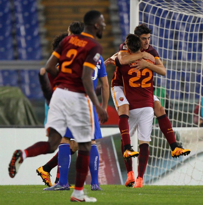 Roma winger Diego Perotti is carried by teammate Stephan El Shaarawy (#22) after he scores the team's second goal against Sampdoria.