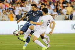 Argentina winger Ezequiel Lavezzi (#22) competes for the ball against two Bolivia defenders.