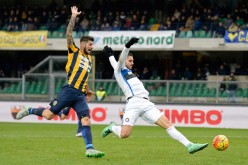 Inter captain Mauro Icardi (R) competes for the ball against Verona defender Eros Pisano.