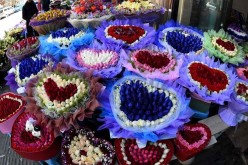 Roses of different colors are seen at a flower market in Kunming, capital of southwest China's Yunnan Province, Feb. 14, 2016.