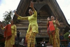Sumatran women dance the Tor-tor folk dance to welcome tourists at the Tuk-tuk village in Samosir, Indonesia's North Sumatra Province.