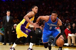 Oklahoma City point guard Russell Westbrook (R) drives past Los Angeles Lakers' Jordan Clarkson.
