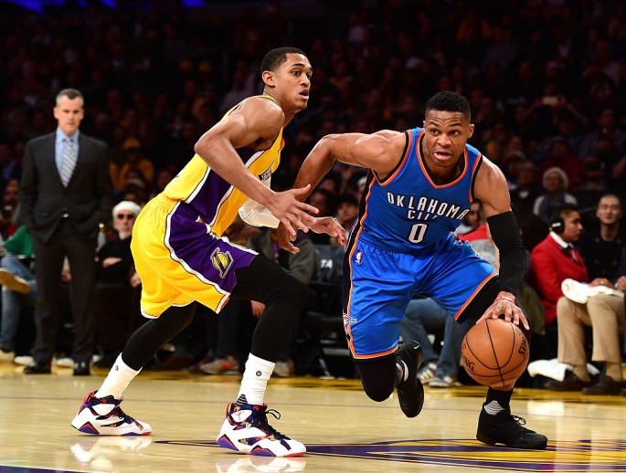 Oklahoma City point guard Russell Westbrook (R) drives past Los Angeles Lakers' Jordan Clarkson.