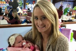 Leah Messer holds a baby at her daughter's birthday party.
