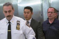 New York City Police (NYPD) officer Peter Liang (C) leaves the courtroom after an arraignment hearing in the Brooklyn borough of New York City on Feb. 11. 