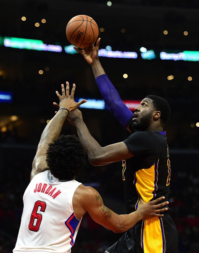 Los Angeles Lakers center Roy Hibbert (R) skyhooks over Los Angeles Clippers' DeAndre Jordan.