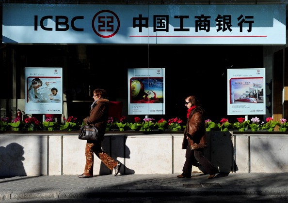 Two women stroll by a branch of the Industrial and Commercial Bank of China (ICBC) in Madrid, Spain, on Jan. 24, 2011.