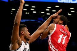 Memphis Grizzlies point guard Mike Conley (R) drives against Brooklyn Nets' Thaddeus Young.