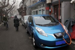 A new energy vehicle using a charging facility in Dongsishitiao Hutong. China has pushed for an increased number of purchases of such vehicles for government use.