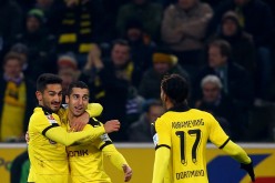 Borussia Dortmund winger Henrikh Mkhitaryan celebrates his goal against Hannover with teammates Ilkay Gundogan and Pierre-Emerick Aubameyang.