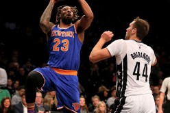 New York Knicks forward Derrick Williams takes a shot against Brooklyn Nets Bojan Bogdanovic.