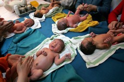 Nurses and parents massage newborn babies at Xining Children Hospital on May 17, 2006, in Xining of Qinghai Province, China.